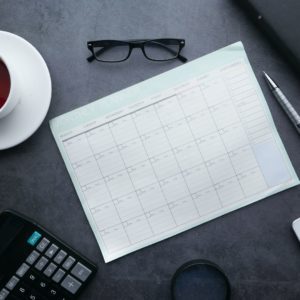 Image of calendar, glasses, coffee cup, calculator